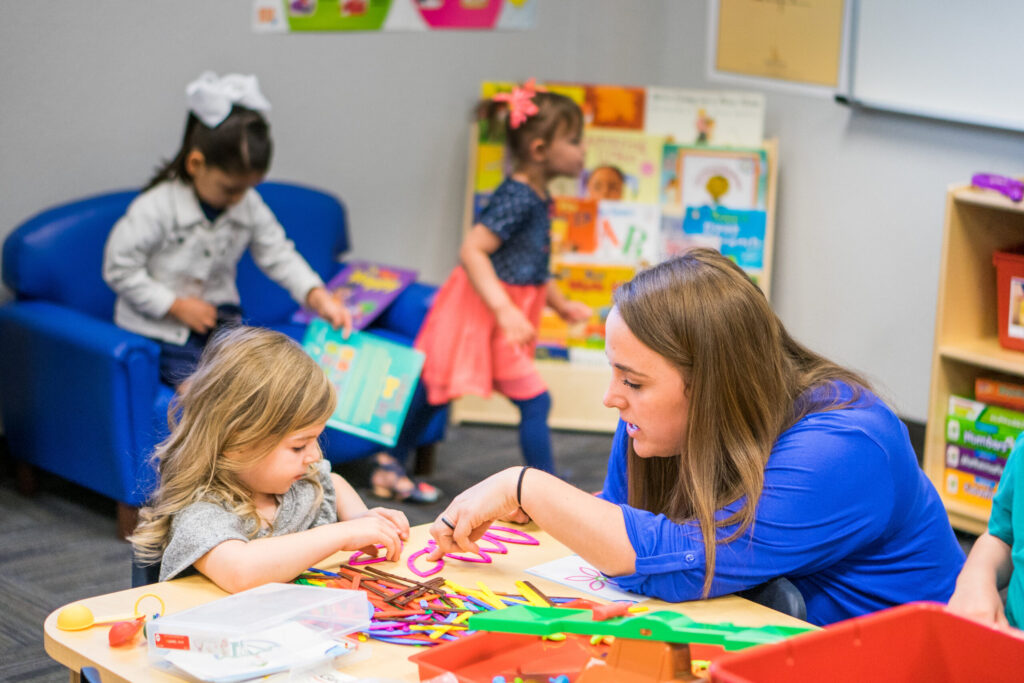 A Teacher at Legacy Traditional Schools helping a Pre Kindergarten Student