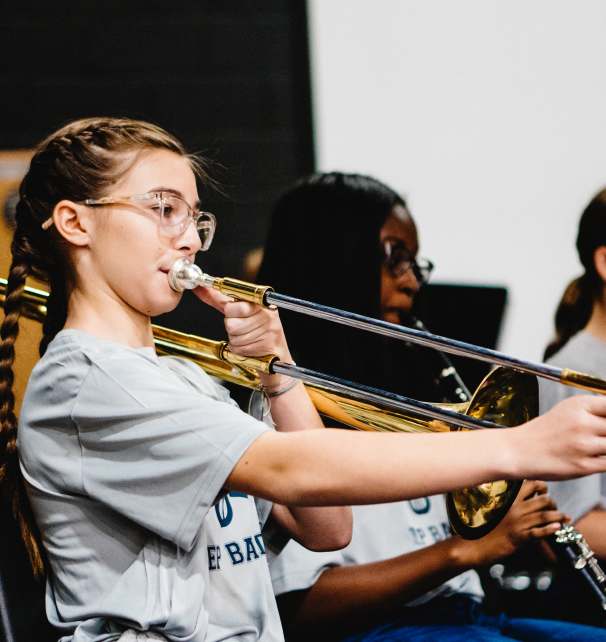 A student plays an instrument as a part of Legacy Traditional Schools' Mozart Performing Arts Program