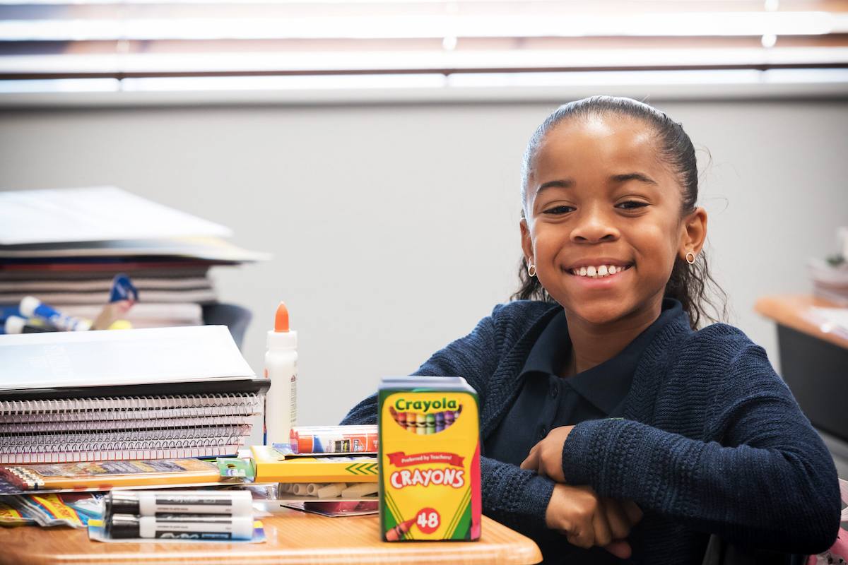 A student shows off her art supplies at Legacy Traditional Schools' Masterpiece Visual Arts program