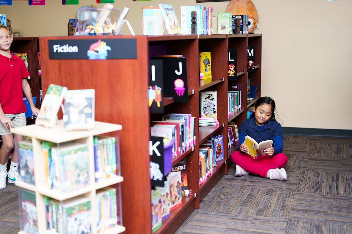 A student reading in the library at Legacy Traditional Schools