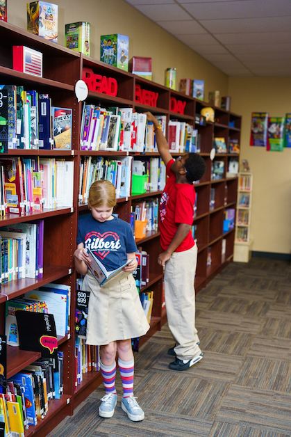 Students checking out books in the Legacy Traditional Schools library